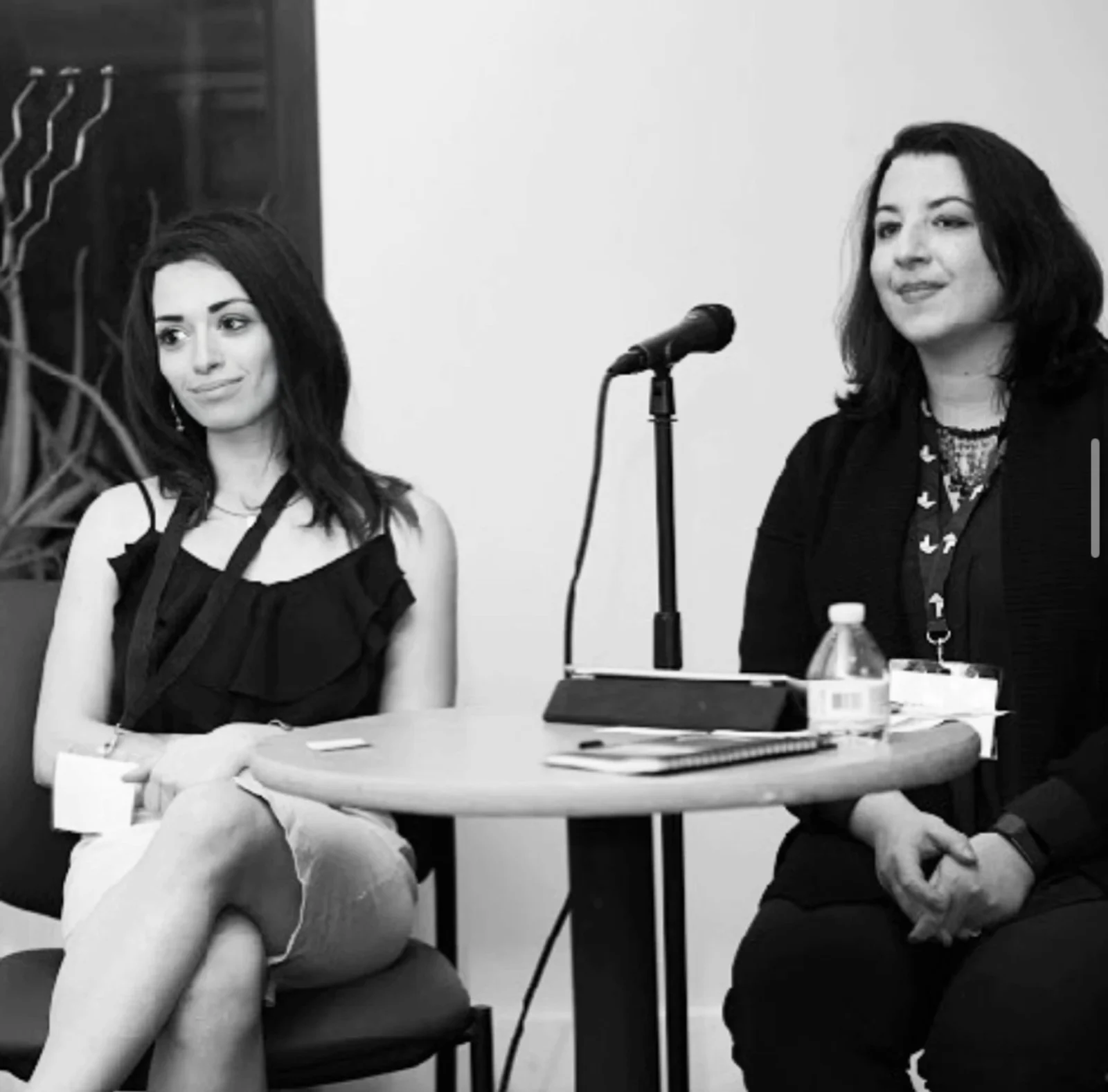 Natalyia in a fireside-chat panel conversation beside a fellow speaker